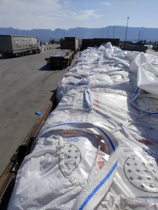 Covered big-bag truck waiting in an open yard